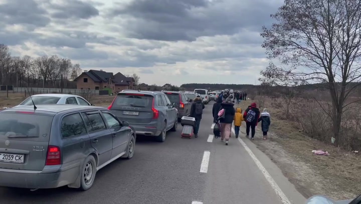 Ukrainians flee Kyiv on foot as cars stuck in long queues to reach Poland