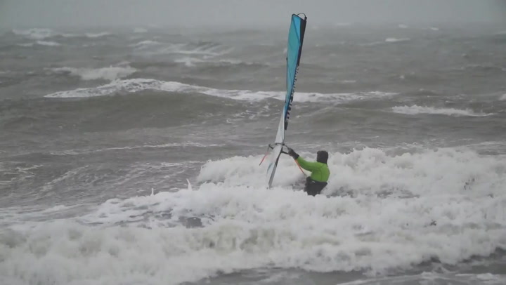 Wind surfers make most of blustery conditions as Storm Franklin is set to strike UK