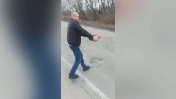 Man appears to move landmine in Ukraine while smoking cigarette