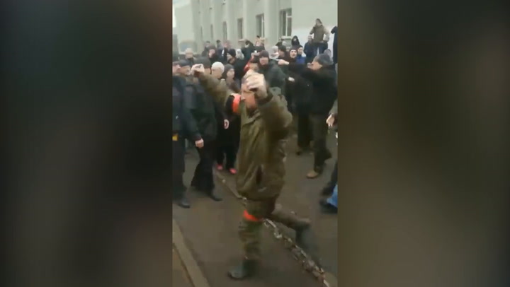 Ukranians jeer and shout at Russian soldier reportedly holding live grenades