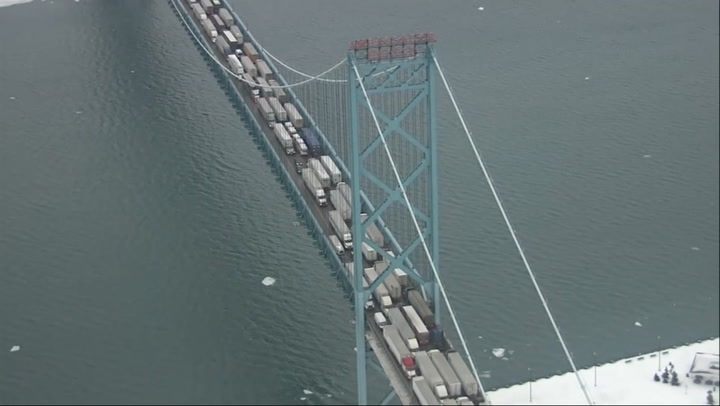 Aerial footage shows heavily congested Ambassador Bridge as truck convoy jams US-Canada border