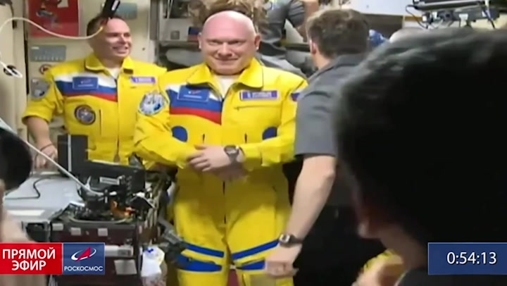Russian cosmonauts arrive at the ISS wearing Ukrainian flag colours