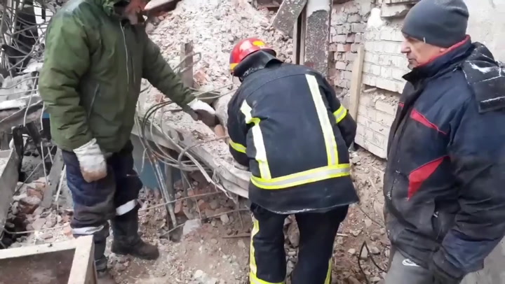 Ukrainian residents and rescuers dismantle destroyed power plant in Okhtyrka