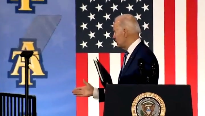 Joe Biden looks confused as he appears to shake hands with thin air